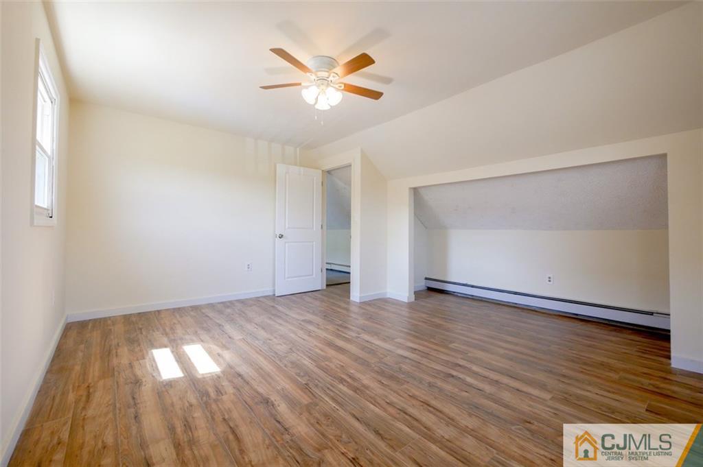 65 Meadow Road Edison, NJ 08817 - Photo 19 of 24 an empty room with wooden floor and windows
