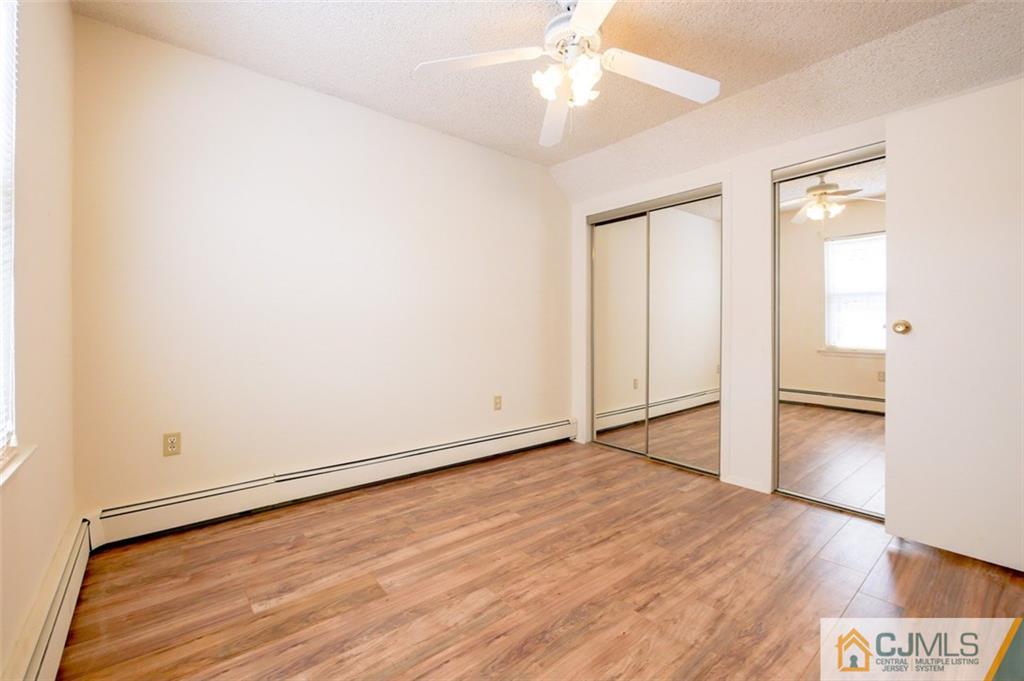 65 Meadow Road Edison, NJ 08817 - Photo 22 of 24 an empty room with wooden floor and ceiling fan