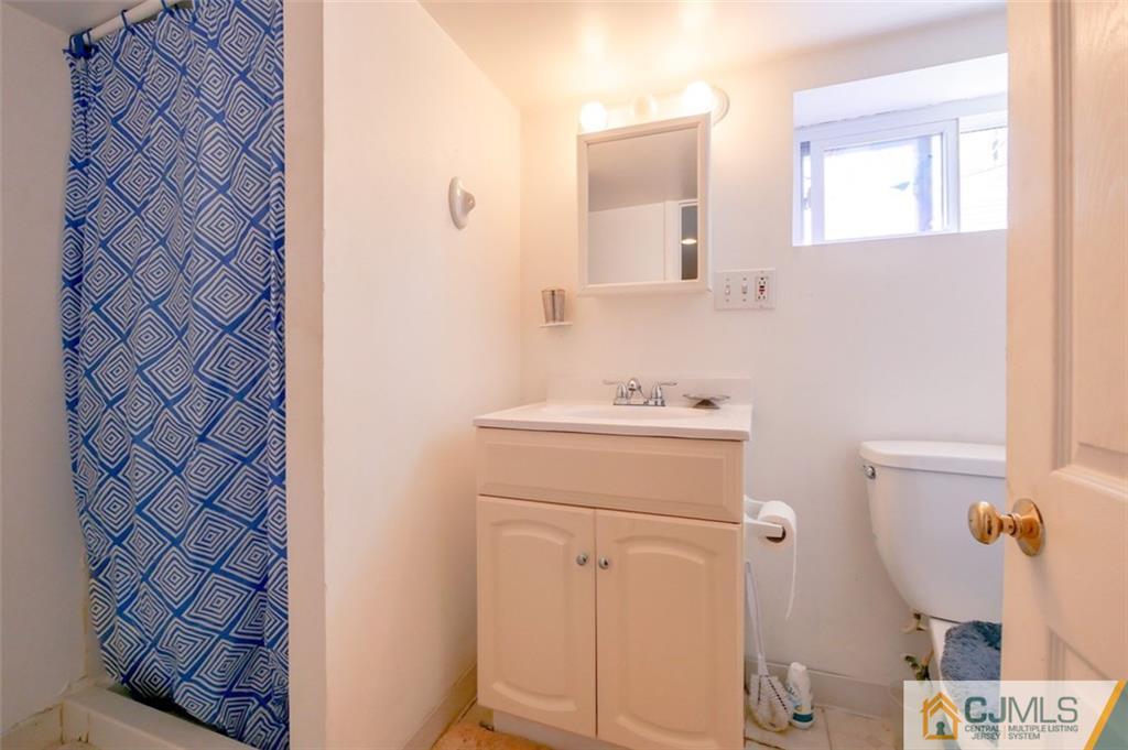 65 Meadow Road Edison, NJ 08817 - Photo 24 of 24 a bathroom with a sink and a mirror