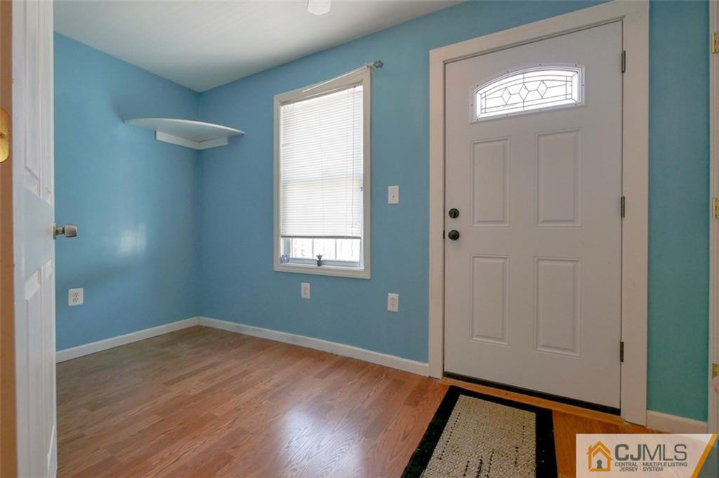 65 Meadow Road Edison, NJ 08817 - Photo 6 of 24 a view of empty room with window and wooden floor