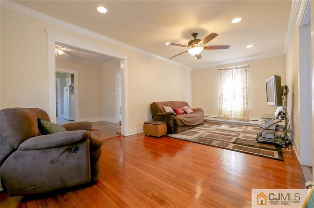 65 Meadow Road Edison, NJ 08817 - Photo 8 of 24 a living room with furniture and a chandelier