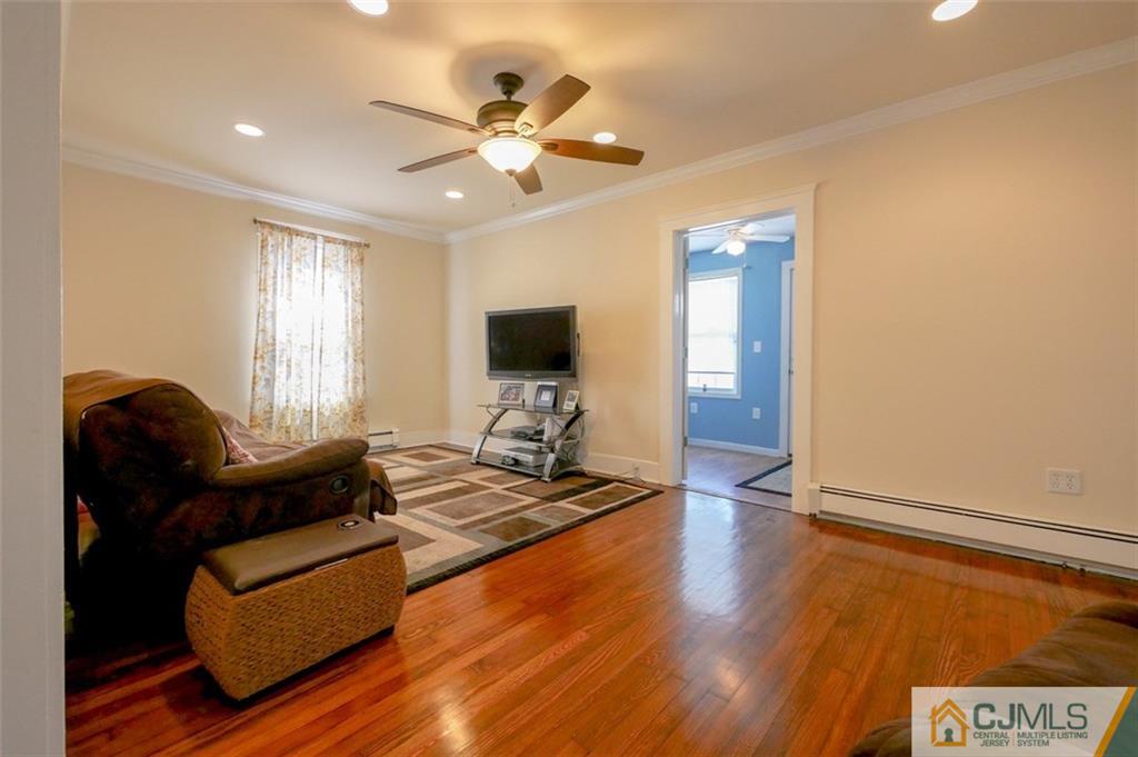 65 Meadow Road Edison, NJ 08817 - Photo 9 of 24 a living room with furniture and wooden floor