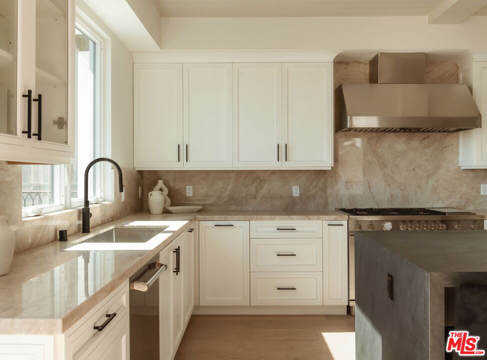10725 Ashton Avenue, Unit 101 Los Angeles, CA 90024 - Photo 11 of 40 a kitchen with white cabinets and sink