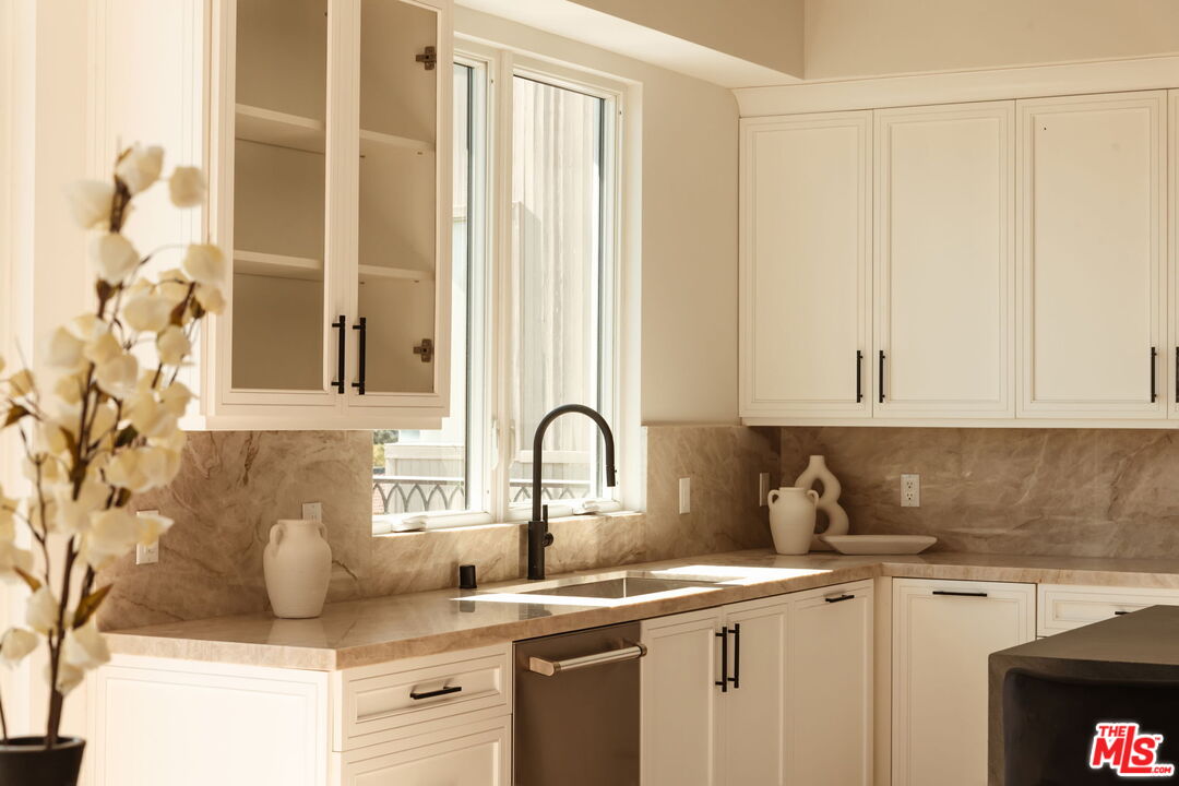 10725 Ashton Avenue, Unit 101 Los Angeles, CA 90024 - Photo 13 of 40 a kitchen with stainless steel appliances granite countertop a sink and a white cabinets