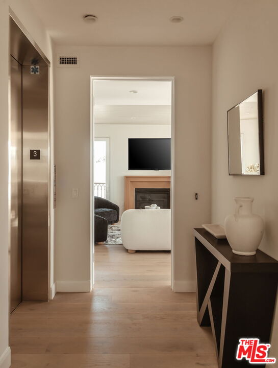 10725 Ashton Avenue, Unit 101 Los Angeles, CA 90024 - Photo 2 of 40 a living room with a couch and a fireplace