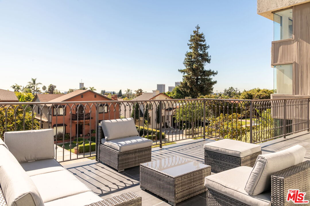 10725 Ashton Avenue, Unit 101 Los Angeles, CA 90024 - Photo 21 of 40 a roof deck with couches and wooden floor
