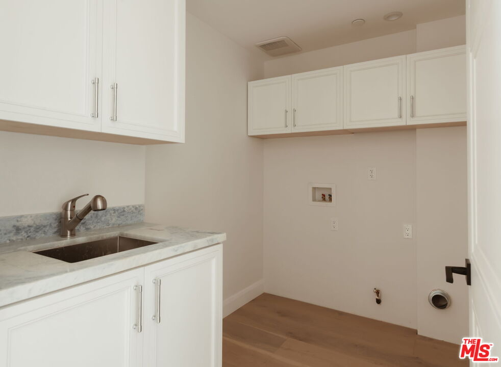 10725 Ashton Avenue, Unit 101 Los Angeles, CA 90024 - Photo 24 of 40 a kitchen with a sink and cabinets