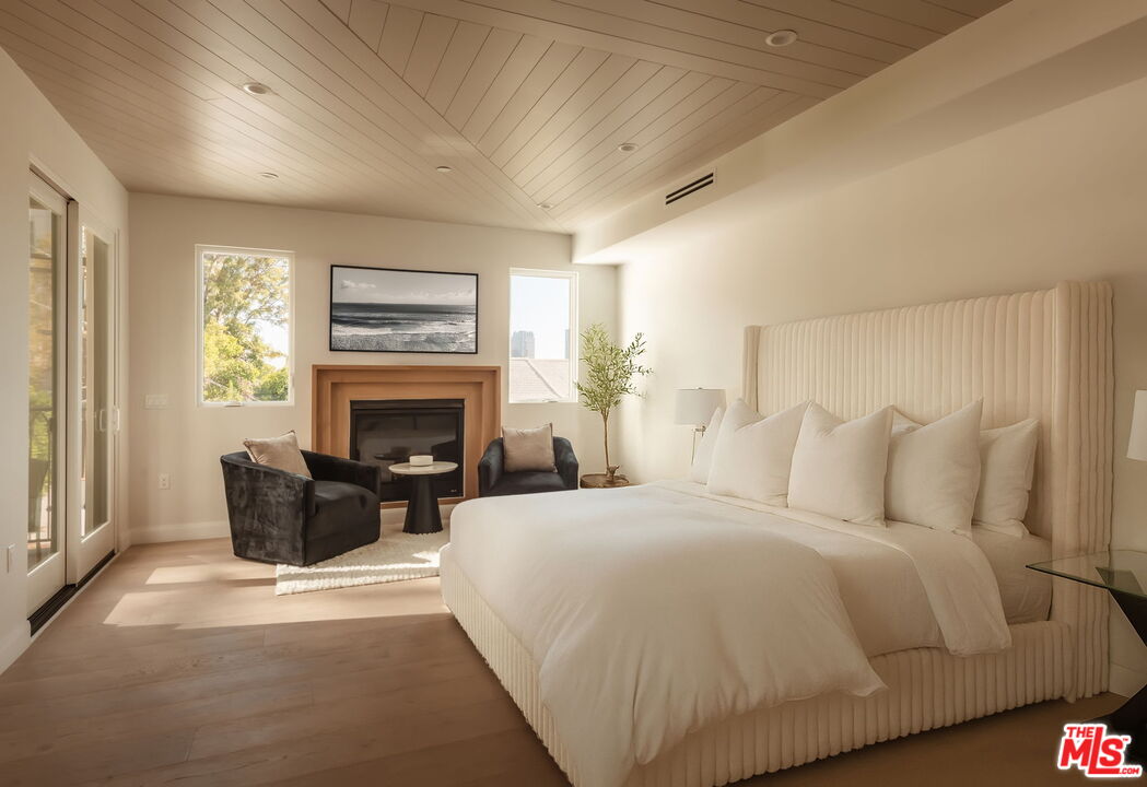 10725 Ashton Avenue, Unit 101 Los Angeles, CA 90024 - Photo 25 of 40 a bedroom with bed and a fireplace