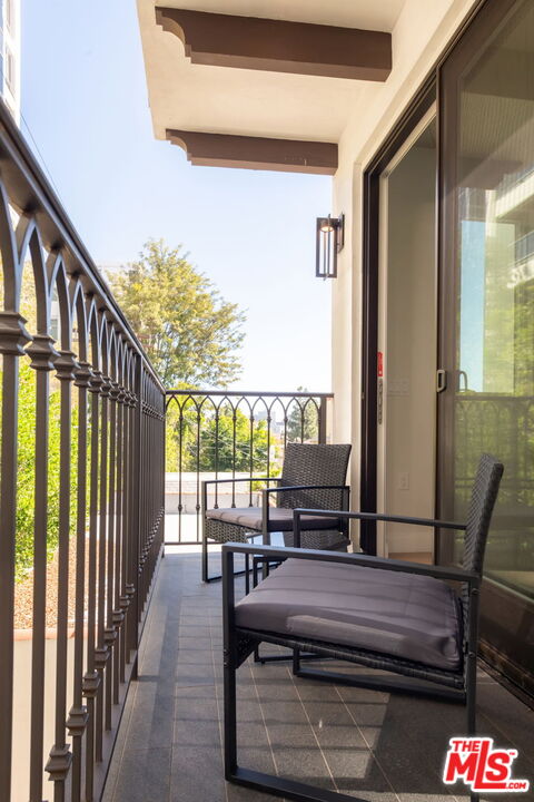 10725 Ashton Avenue, Unit 101 Los Angeles, CA 90024 - Photo 26 of 40 a balcony with view of outdoor seating