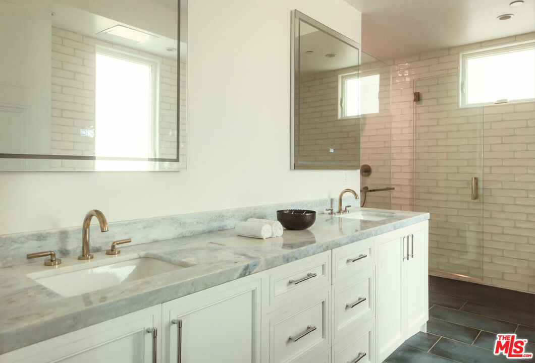 10725 Ashton Avenue, Unit 101 Los Angeles, CA 90024 - Photo 28 of 40 a bathroom with a sink double vanity and mirror