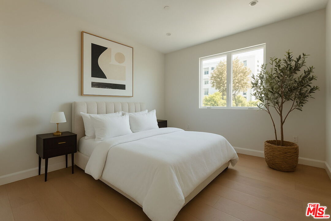 10725 Ashton Avenue, Unit 101 Los Angeles, CA 90024 - Photo 31 of 40 a bedroom with a bed and a potted plant