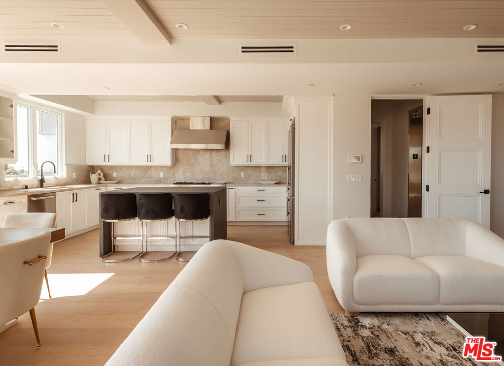 10725 Ashton Avenue, Unit 101 Los Angeles, CA 90024 - Photo 4 of 40 a living room with furniture and view of kitchen