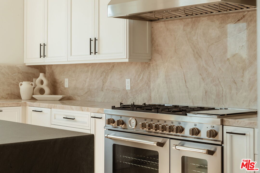 10725 Ashton Avenue, Unit 101 Los Angeles, CA 90024 - Photo 10 of 40 a stove top oven sitting inside of a kitchen