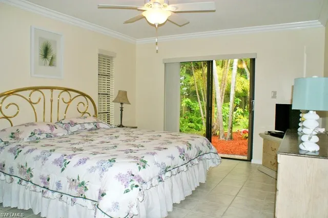 a bedroom with a bed and a large mirror