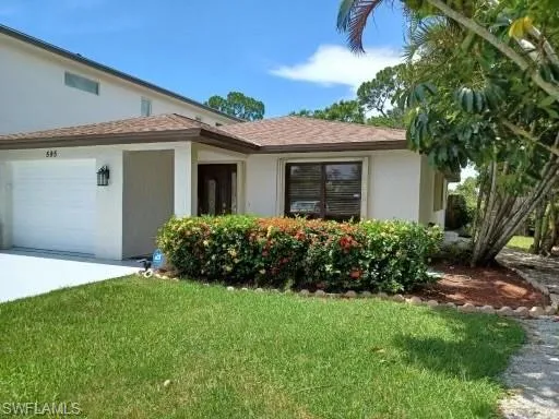 a front view of house with yard and green space