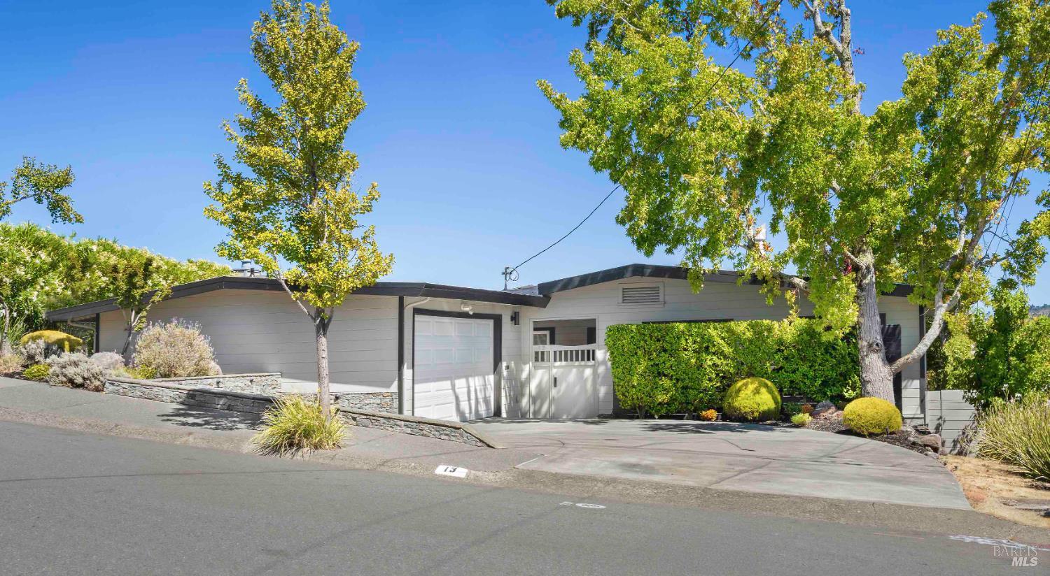 a front view of a house with a yard and a garage