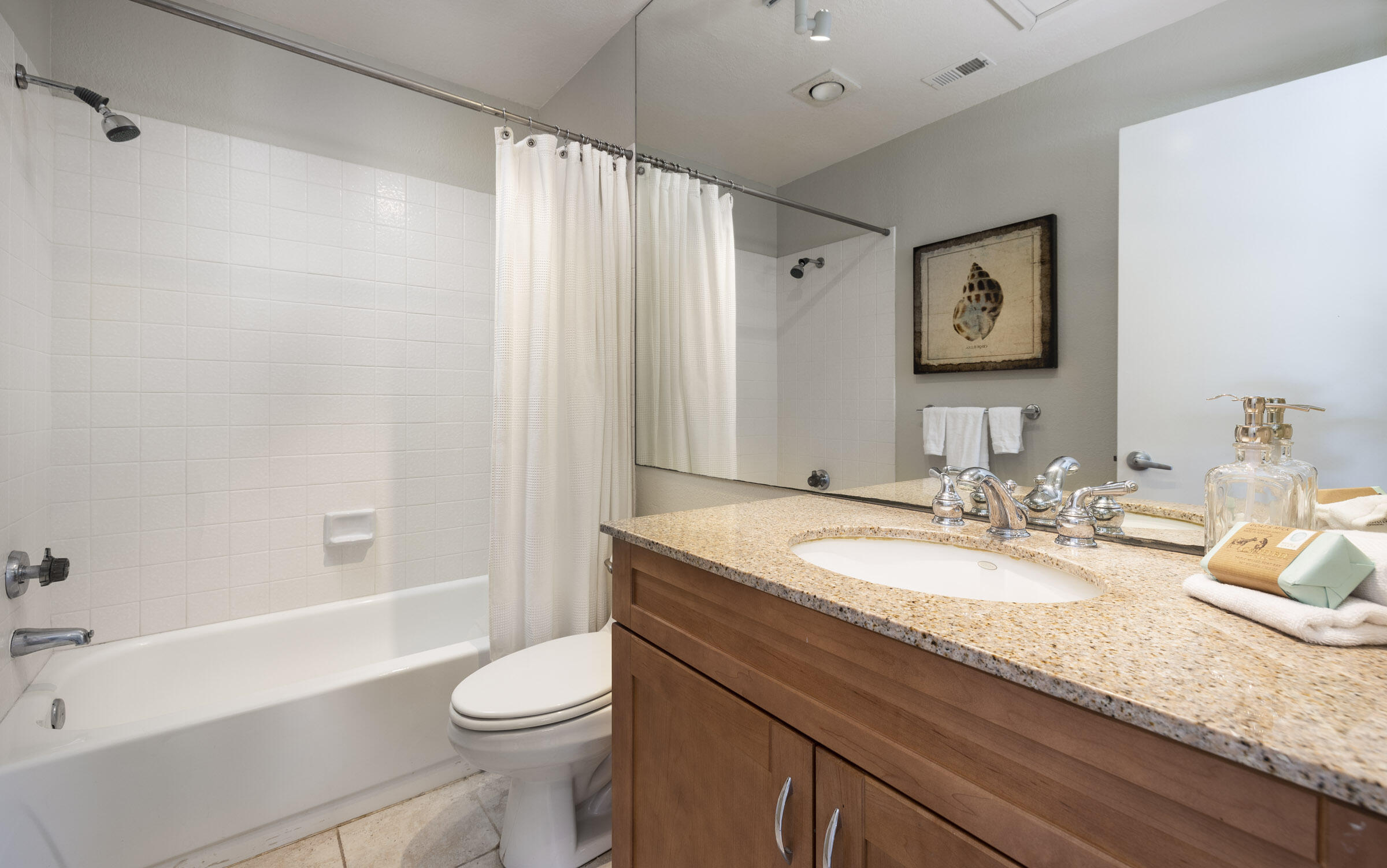 4017 Primavera Road, Unit A Santa Barbara, CA 93110 - Photo 11 of 17 a bathroom with a granite countertop sink toilet and shower