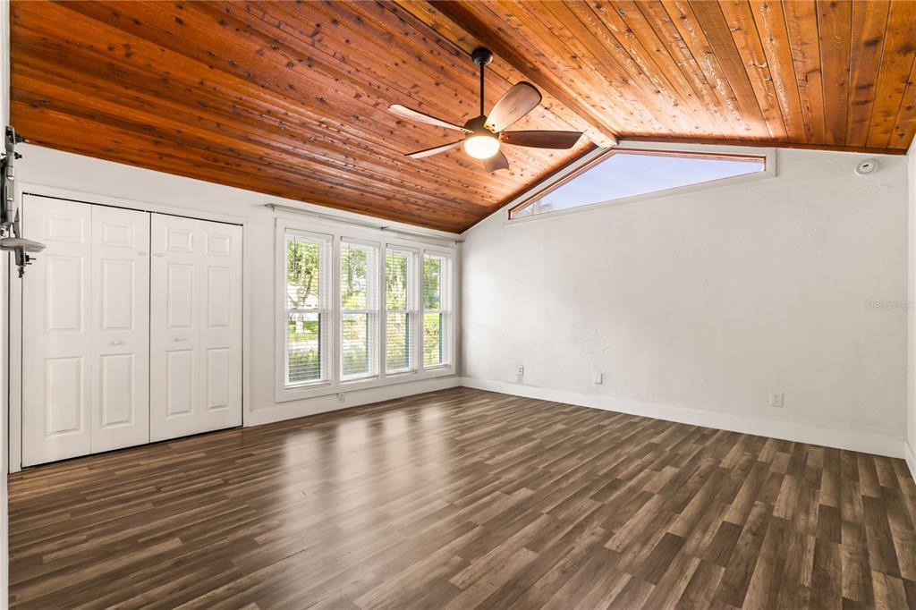 4951 Courtland Loop Winter Springs, FL 32708 - Photo 18 of 36 a view of an empty room with wooden floor and a window