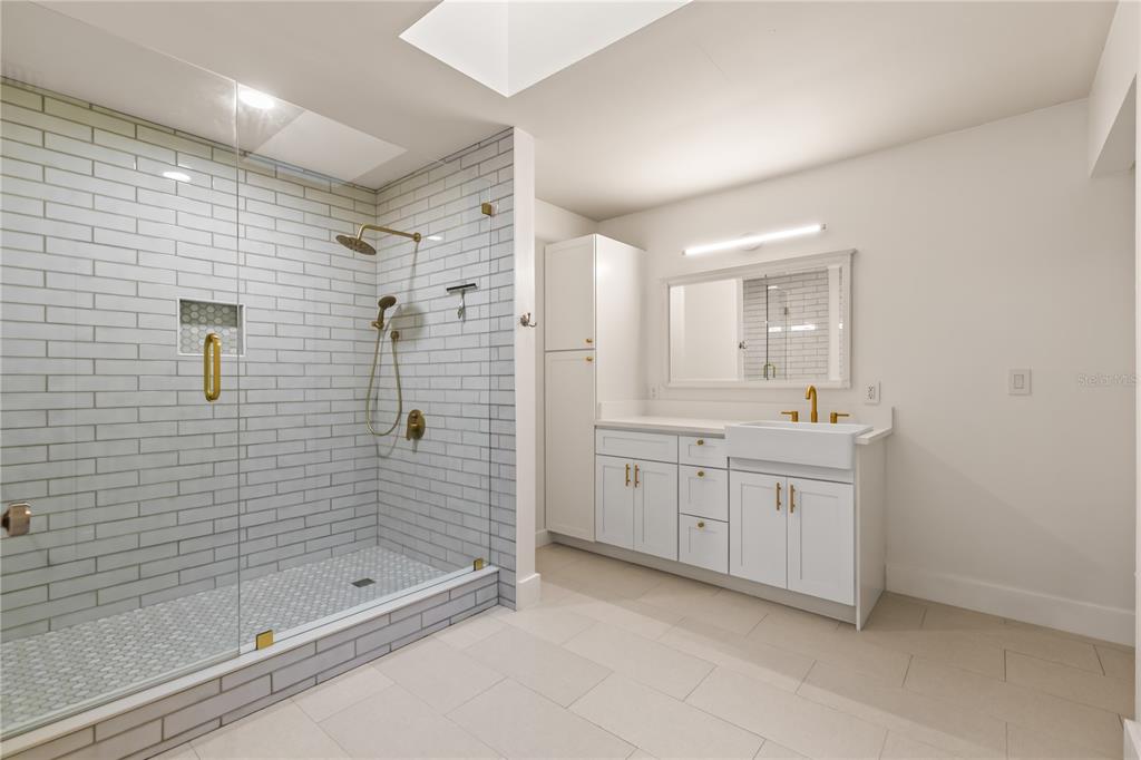 4951 Courtland Loop Winter Springs, FL 32708 - Photo 20 of 36 a bathroom with a shower sink and mirror