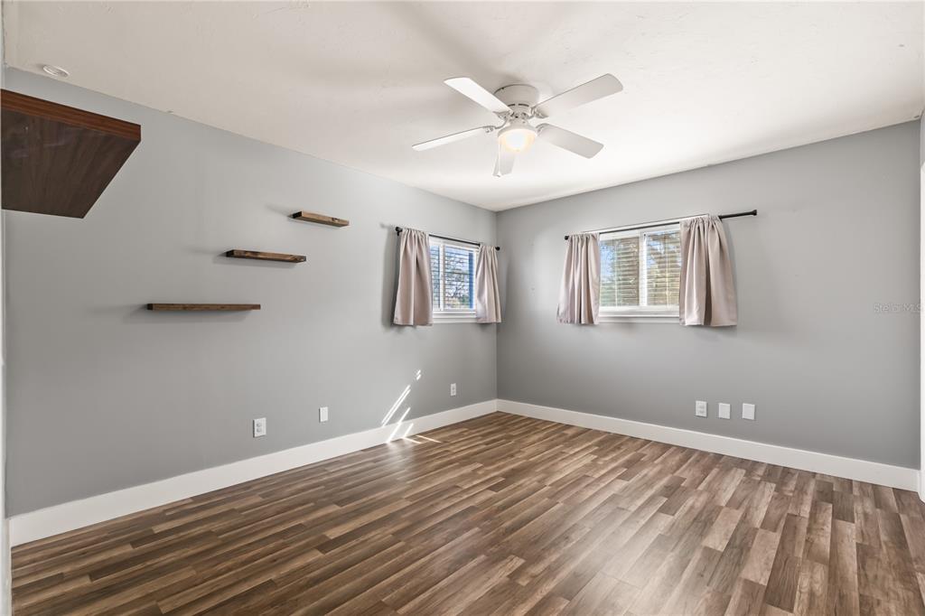 4951 Courtland Loop Winter Springs, FL 32708 - Photo 21 of 36 a view of an empty room with wooden floor and a window