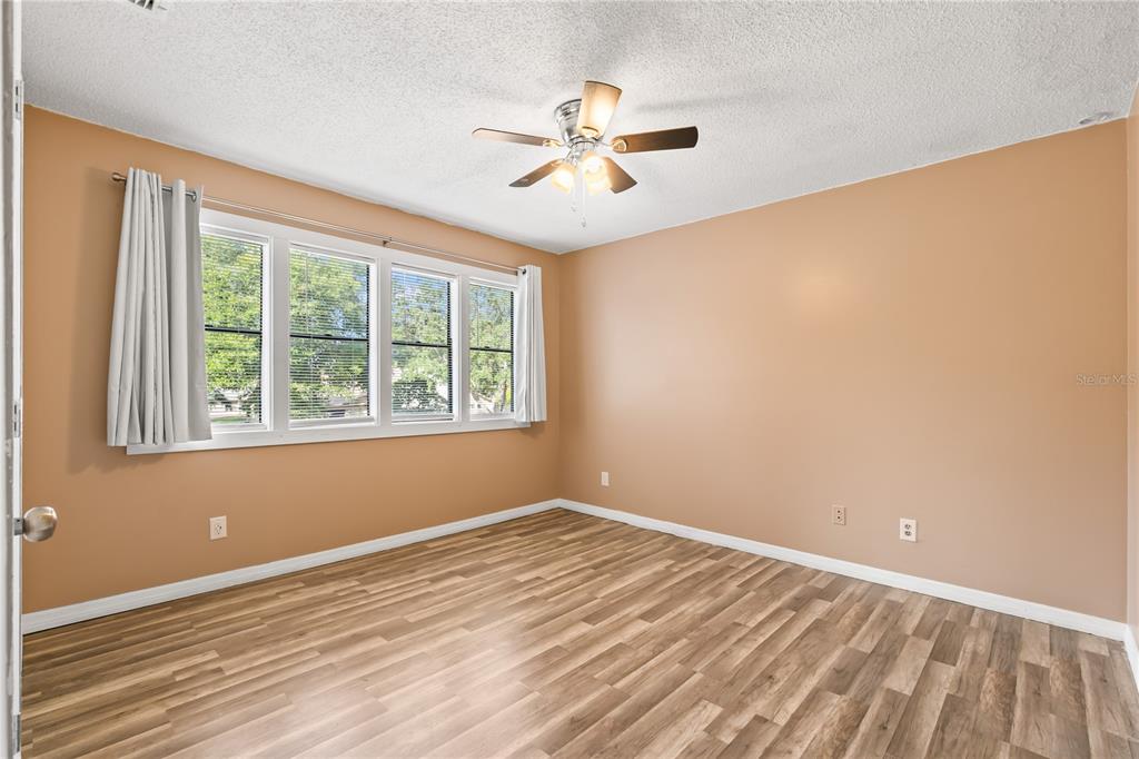 4951 Courtland Loop Winter Springs, FL 32708 - Photo 24 of 36 wooden floor in an empty room with a window