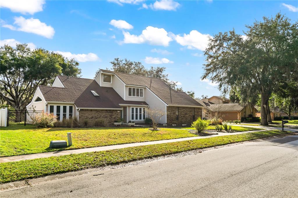 4951 Courtland Loop Winter Springs, FL 32708 - Photo 31 of 36 a front view of house with yard and green space
