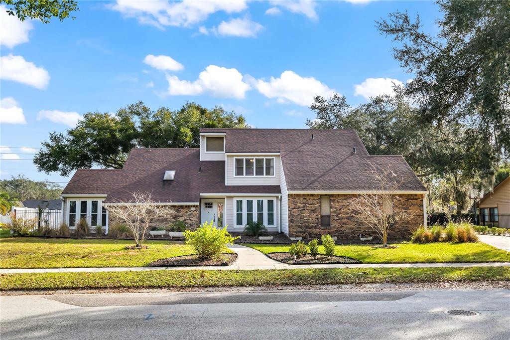 4951 Courtland Loop Winter Springs, FL 32708 - Photo 32 of 36 a front view of a house with a garden