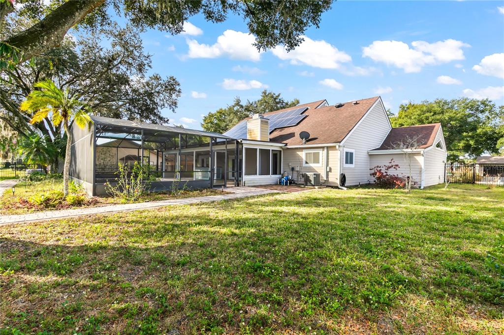 4951 Courtland Loop Winter Springs, FL 32708 - Photo 5 of 36 a front view of a house with a garden and lake view