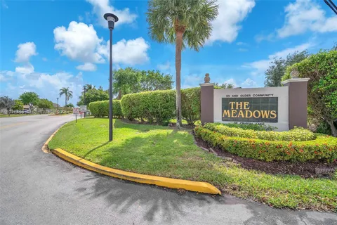 a view of a park with a sign board