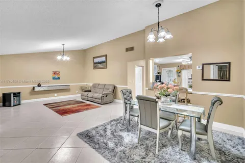 a dining room with furniture and chandelier