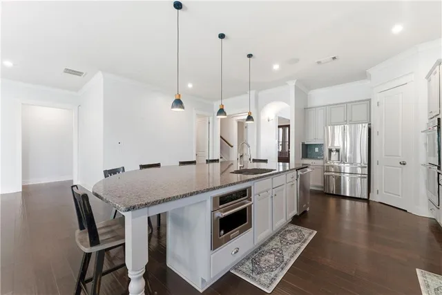 a kitchen with a stove a sink and a refrigerator