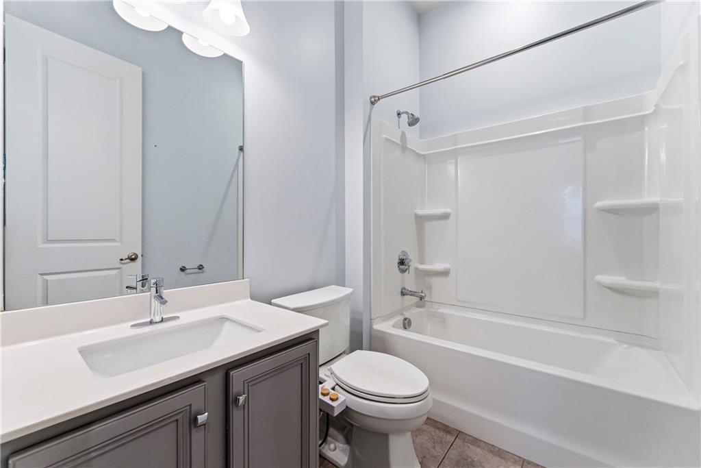 601 Long Leaf Way Canton, GA 30114 - Photo 17 of 42 a bathroom with a sink a toilet and shower
