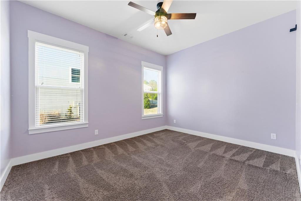 601 Long Leaf Way Canton, GA 30114 - Photo 18 of 42 an empty room with windows and fan