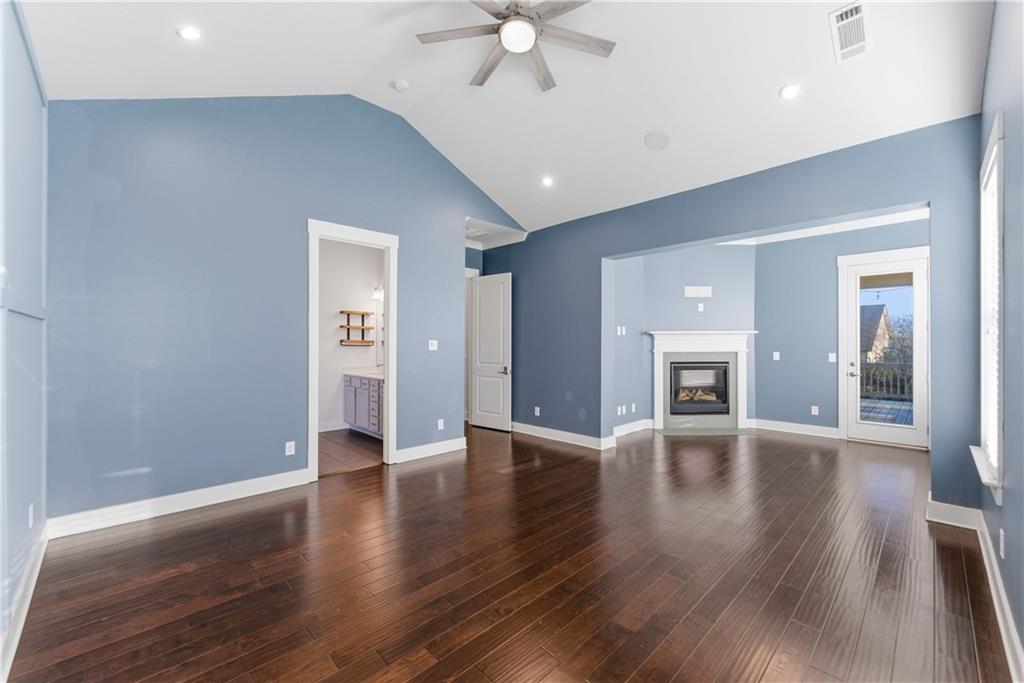 601 Long Leaf Way Canton, GA 30114 - Photo 20 of 42 a view of an empty room with wooden floor and a ceiling fan