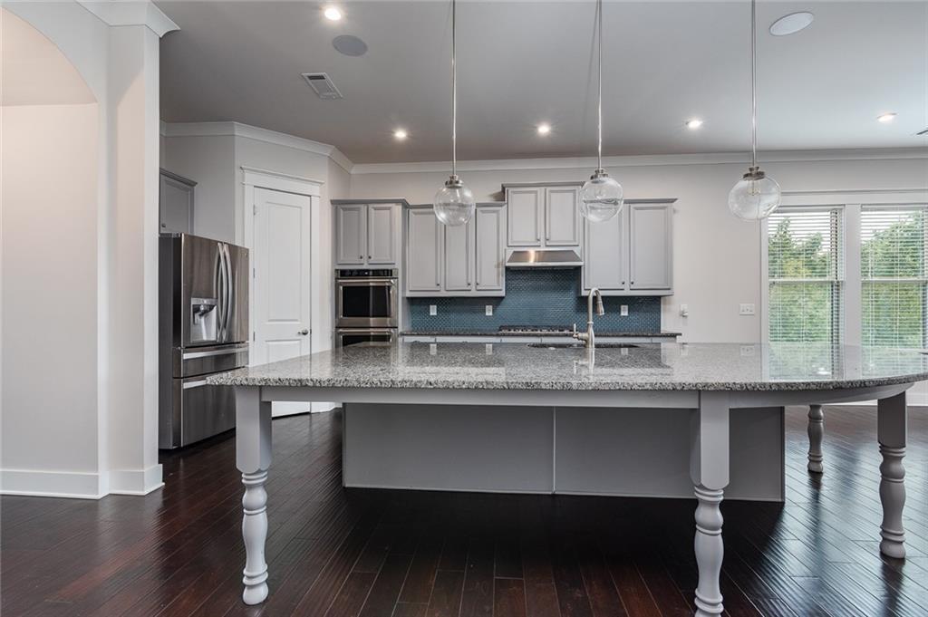 601 Long Leaf Way Canton, GA 30114 - Photo 2 of 42 a kitchen with stainless steel appliances granite countertop a sink a stove a refrigerator and cabinets