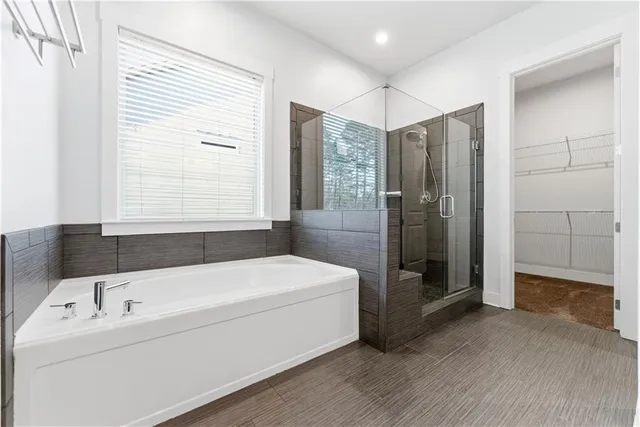 a bathroom with a tub a sink and a shower