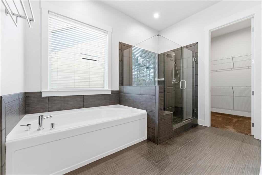 601 Long Leaf Way Canton, GA 30114 - Photo 23 of 42 a bathroom with a tub a sink and a shower
