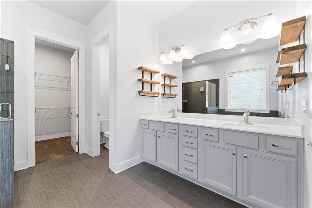 601 Long Leaf Way Canton, GA 30114 - Photo 24 of 42 a spacious bathroom with a double vanity sink a mirror and a shower