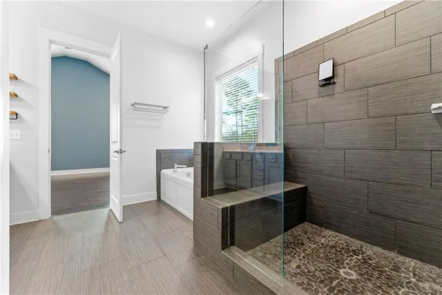 a bathroom with a bathtub and shower