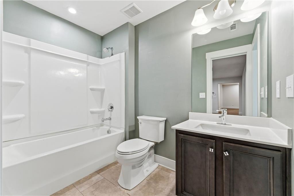 601 Long Leaf Way Canton, GA 30114 - Photo 30 of 42 a bathroom with a sink a toilet and shower
