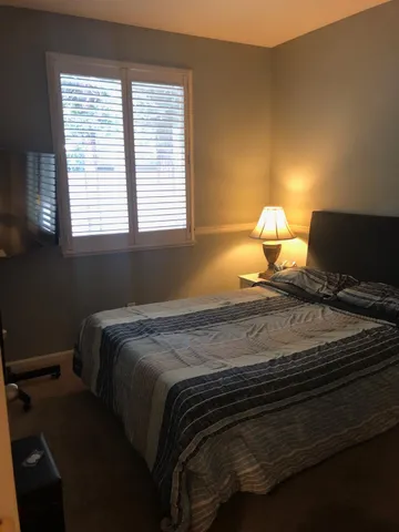 a bedroom with a bed and a window