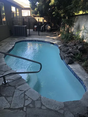 a view of a backyard with sitting area