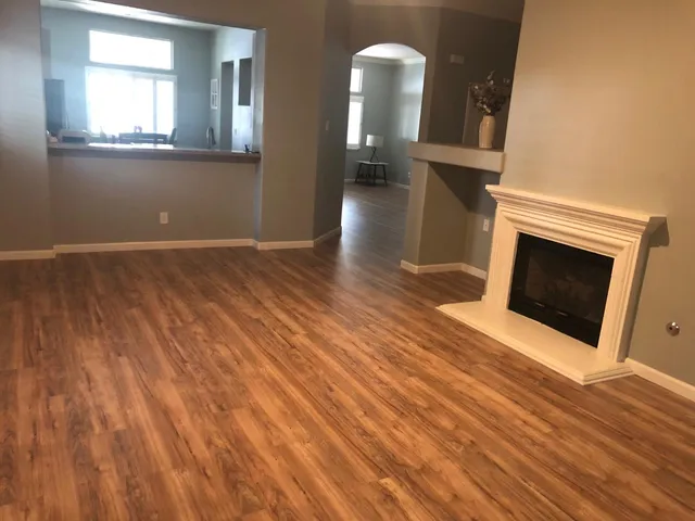 a view of a livingroom with wooden floor and fireplace