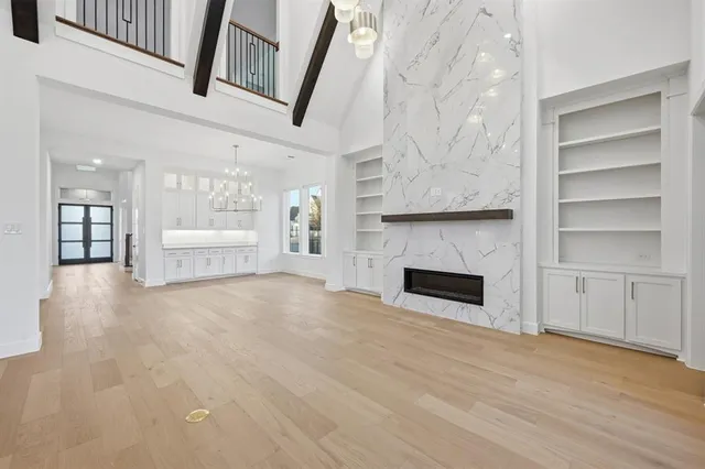 a view of an empty room with a fireplace and a window