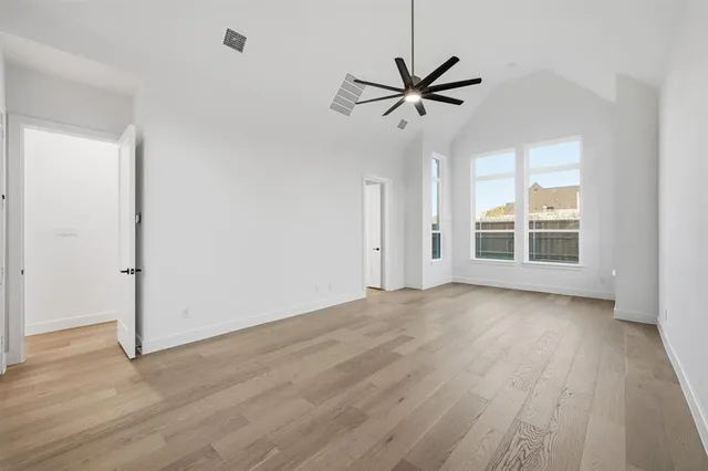 a view of a room with wooden floor and window
