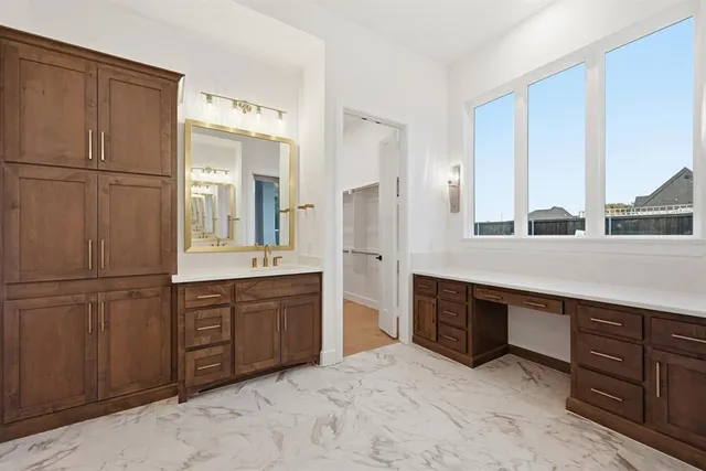a spacious bathroom with a double vanity sink and a mirror