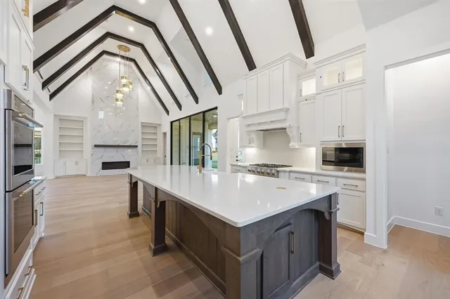 a kitchen with a sink and a stove top oven