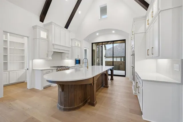 a kitchen with stainless steel appliances granite countertop a sink a stove and a refrigerator