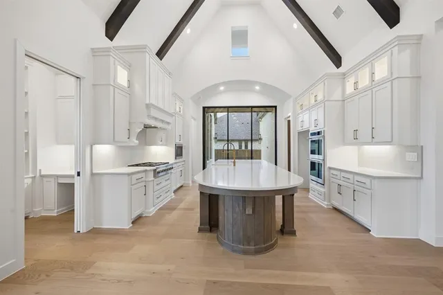 a kitchen with counter top space a sink stainless steel appliances and cabinets