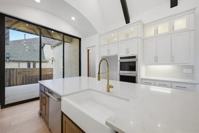 a kitchen with a stove a sink and a refrigerator